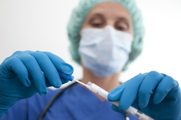 masked nurse asservating an assay