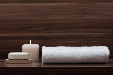 arrangement of soap, towel and candle