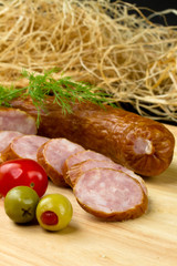 Polish kielbasa with olives and tomatoes