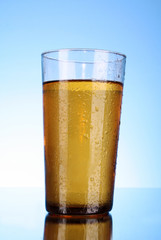 Cup of beer on blue background