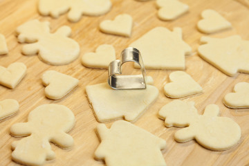 cut dough snowman, house, heart, and forms for cookies