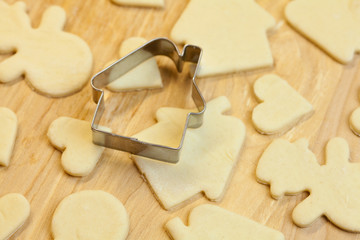 cut dough snowman, house, heart, and forms for cookies