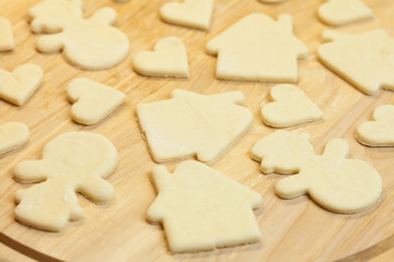 cut in the dough snowman, heart, and  house