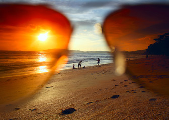 Sunset at the beach through the sunglasses