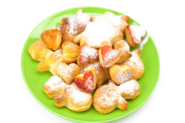 cookies with powdered sugar on a plate isolated on white