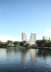 Fototapeta na wymiar Buildings of a city with reflection in the water. Kuala Lumpur