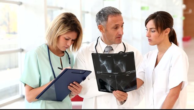 Medical team looking at x-ray in hospital