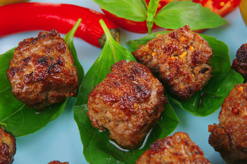 roast meat balls on basil