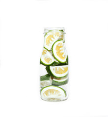 Green lemon slices in a bottle