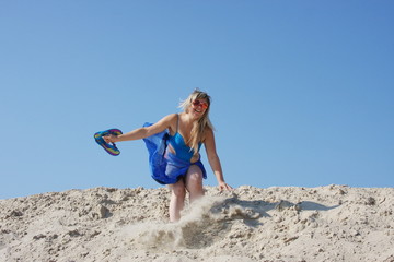young girl on a sand-pit