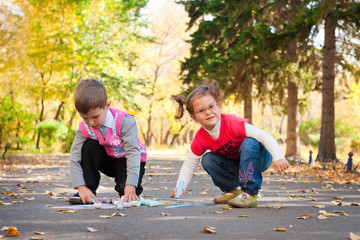 children draw with chalk