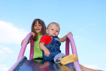 Fototapeta premium The girl and the baby sit on a hill