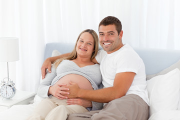 Cute couple resting together on a bed