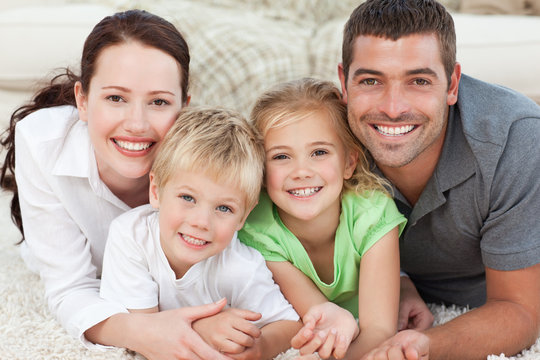 Portrait of a smiling family in the carpet