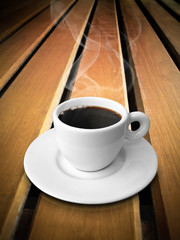 White ceramic of coffee on wood