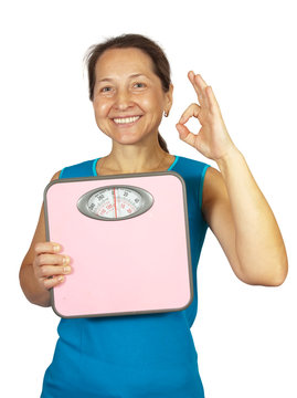 caucasian woman holding scale