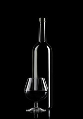 Glass of Wine and Wine Bottle on dark background