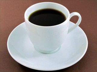 Cup of coffee on brown background