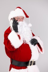 Santa talking on mobile looking at camera