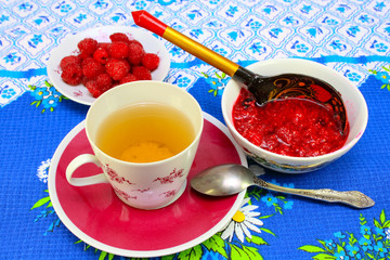A cup of tea and raspberry jam