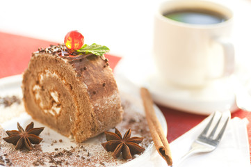 Chocolate biscuit roll with a cup of coffee