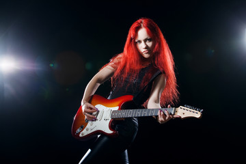 Fototapeta na wymiar red-haired girl the guitarist