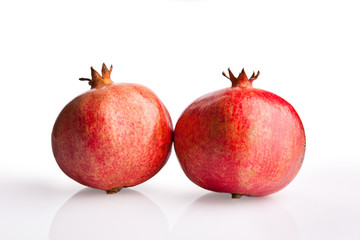 two pomegranates on white