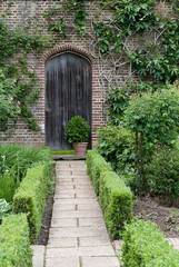 Secret garden. English garden path and door
