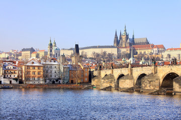Fototapeta na wymiar First Snow in Prague, gothic Castle with the Charles Bridge