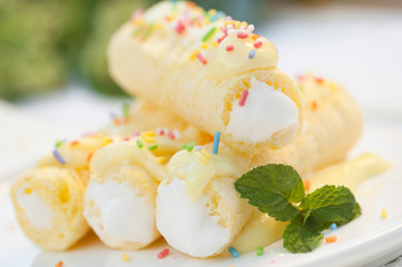 cream roll with vanilla cream and colored sugar streusel
