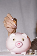 young woman with pink piggy bank