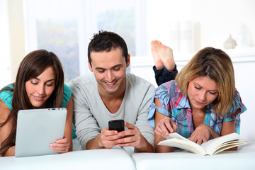 Group of friends laying in sofa at home