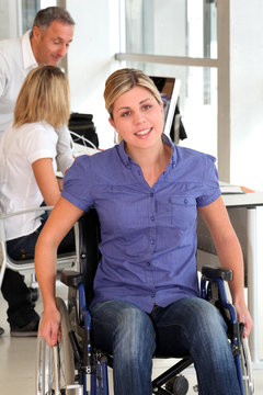 Closeup of young handicapped worker in the office