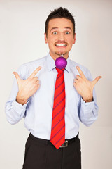 Young man with Christmas Ornament between teeth.