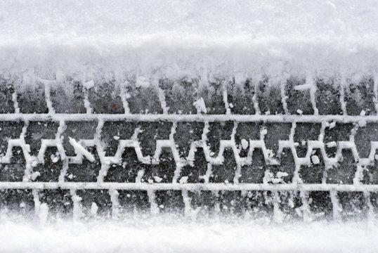 Close-up Tire Tracks In Snow