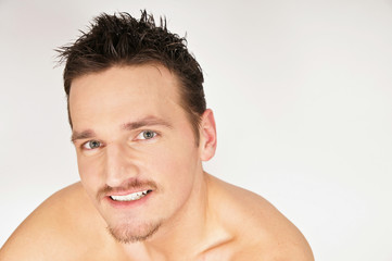 Obraz premium Portrait of young smiling man. You can write text on right side.