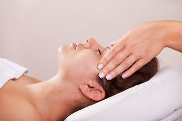 Young beautiful woman getting facial massage