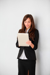 Fototapeta premium Businesswoman standing in hall with electronic pad