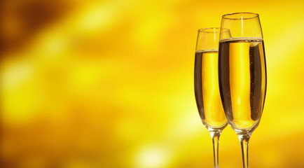 Glass of champagne against golden background