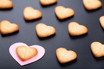 Сrackers with pink paper heart on black background