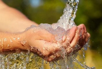 Fototapeta premium Woman's hands with water splash