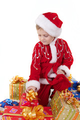 Boy in christmas clothes with presents