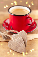 Fototapeta na wymiar espresso coffee, red enamel mug, two wooden hearts and festive