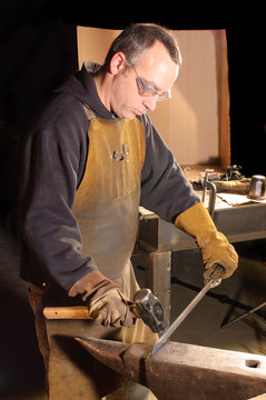 Blacksmith working on decorative handrail