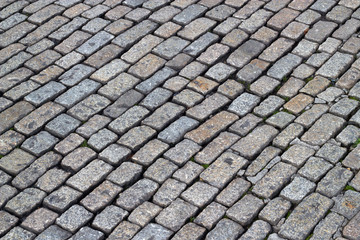Fototapeta premium Old English cobblestones road close up.