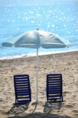 Ashore  in  day-time on sand two chairs cost under umbrella