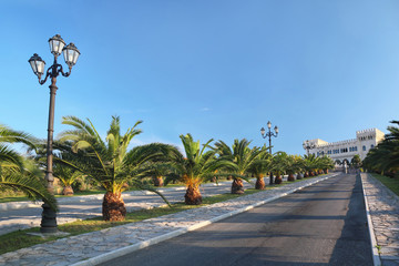 Fototapeta premium View on palace at end of street with palms and lanterns