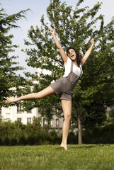 jeune fille joyeuse gambadant dans l'herbe