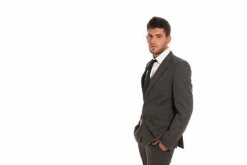 Young businessman copy-space looking hands in pocket isolated