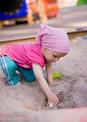 little girl in sandbox
